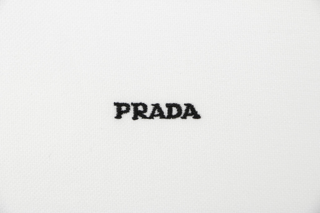Prada PRADA Chenille Wordmark Badge Embroidered Long Sleeve Shirt – White