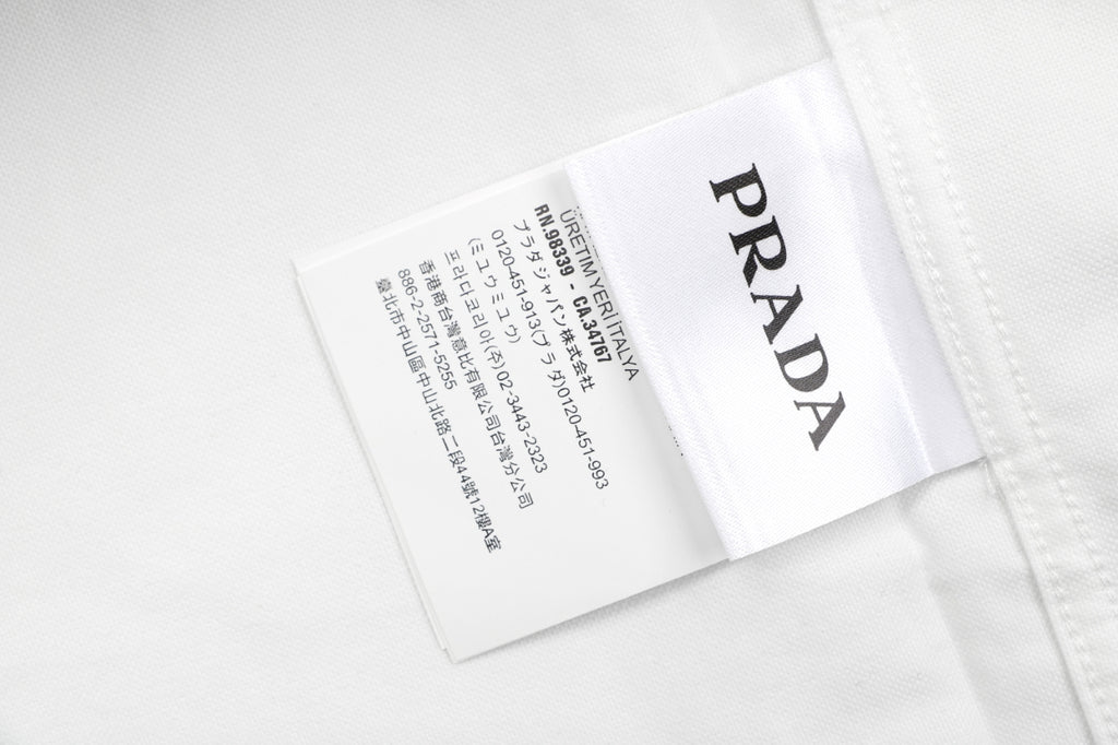 Prada PRADA Chenille Wordmark Badge Embroidered Long Sleeve Shirt – White